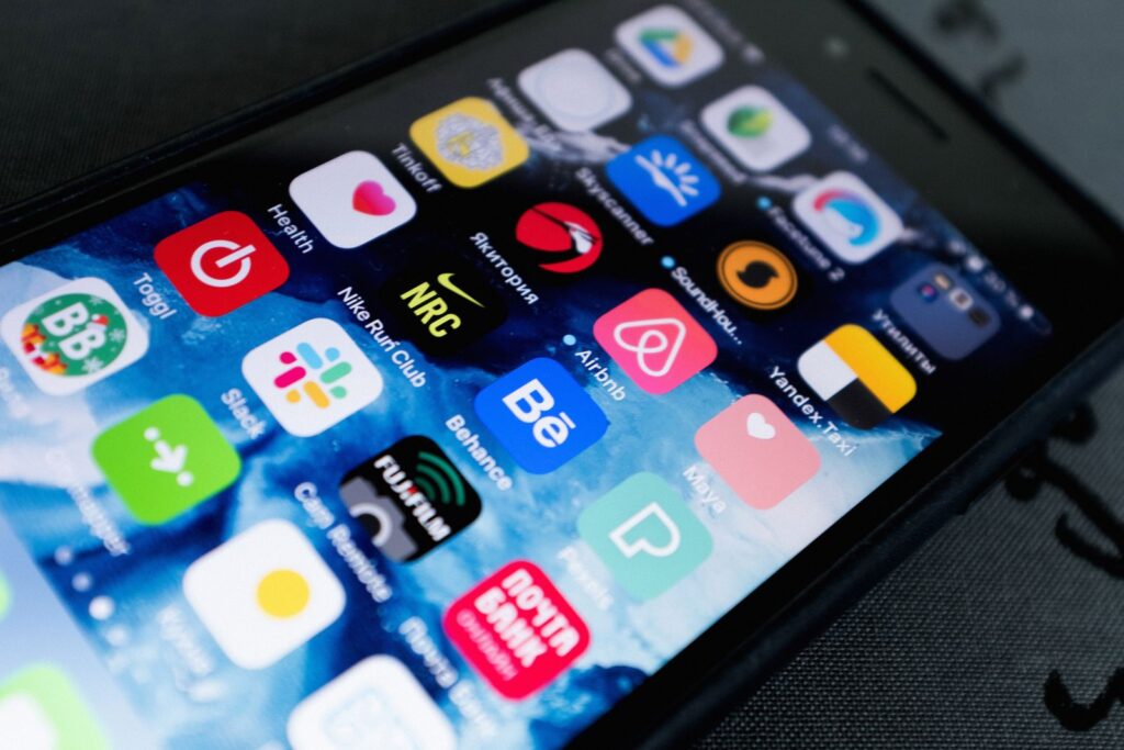 A person scrolling on a smartphone outside